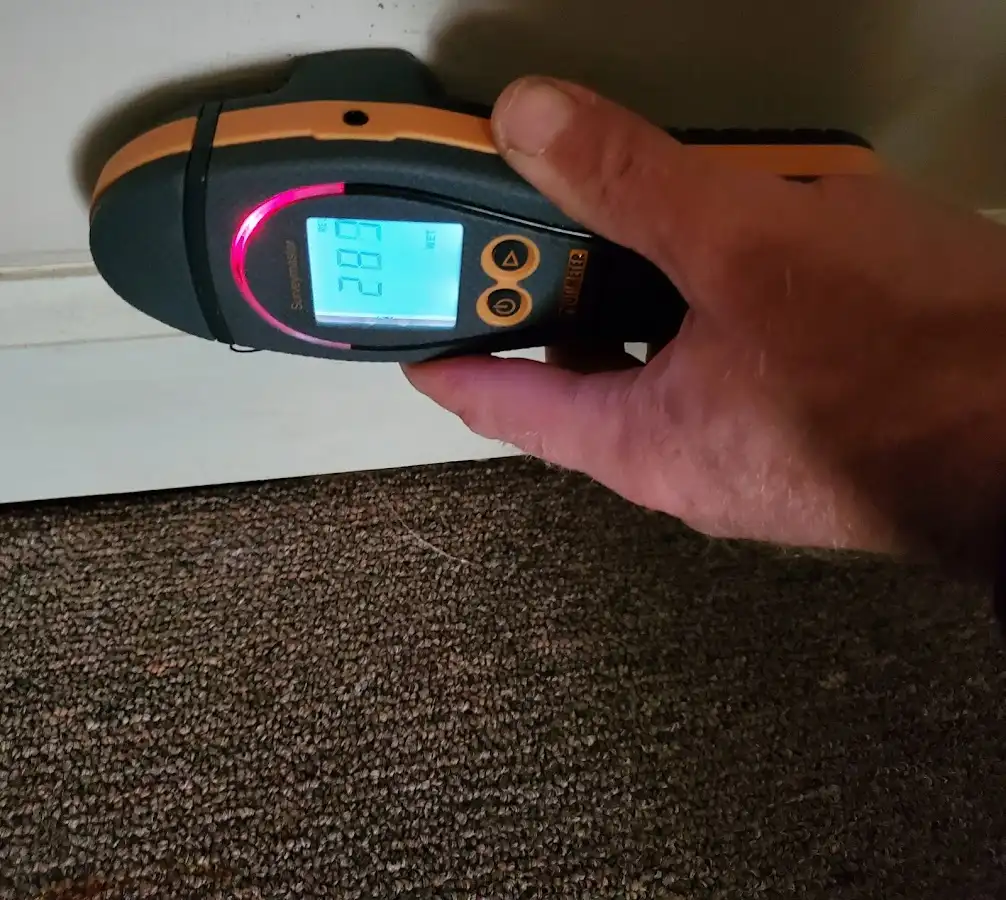 Moisture detection at baseboard during Storm Damage Restoration in Beardstown